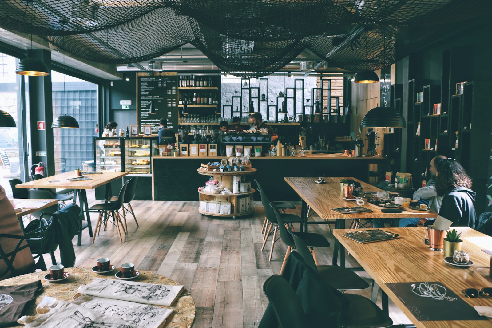 Warm cafe interior with seating and pendant lights